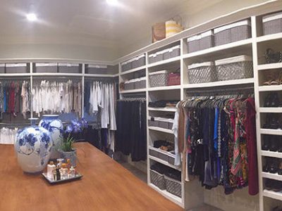 A large closet after having the clothes organized and put away cleanly