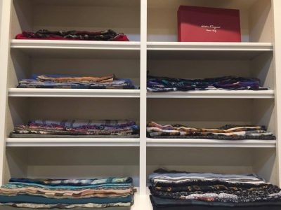 Shelves organized with neatly folded scarves